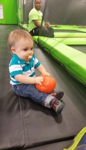 Jake playing at jump house
