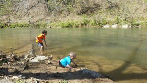 tristan and jake playing in river